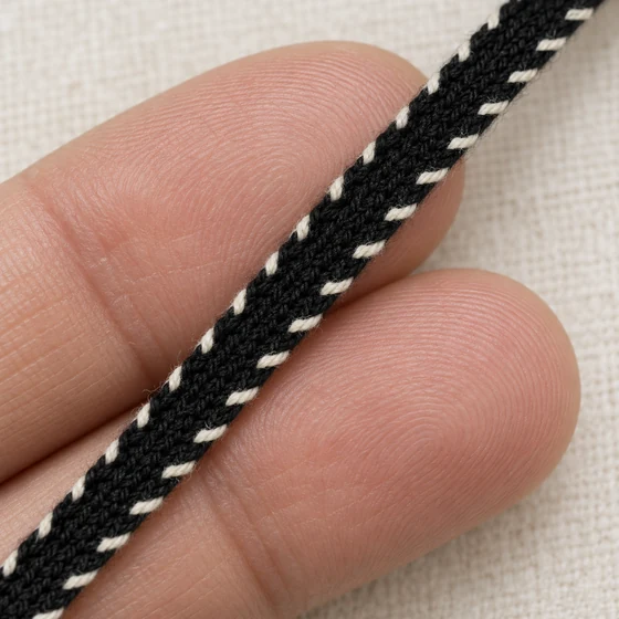 Black and White Narrow Khajuri Braided Trim — In hand