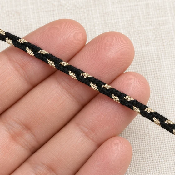 4 mm Black Choti Braided Trim with Champagne Flecks — In hand