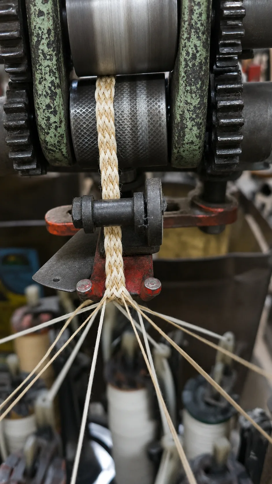Cord twisting machine drawing a braided cord through its rollers at the Jaipur factory