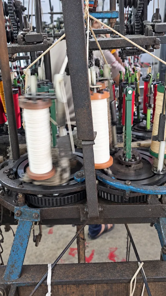 White yarn braiding carriers in our Jaipur factory