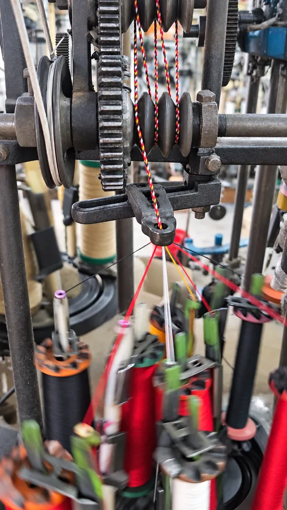 Red patterned cord take-up in our Jaipur factory
