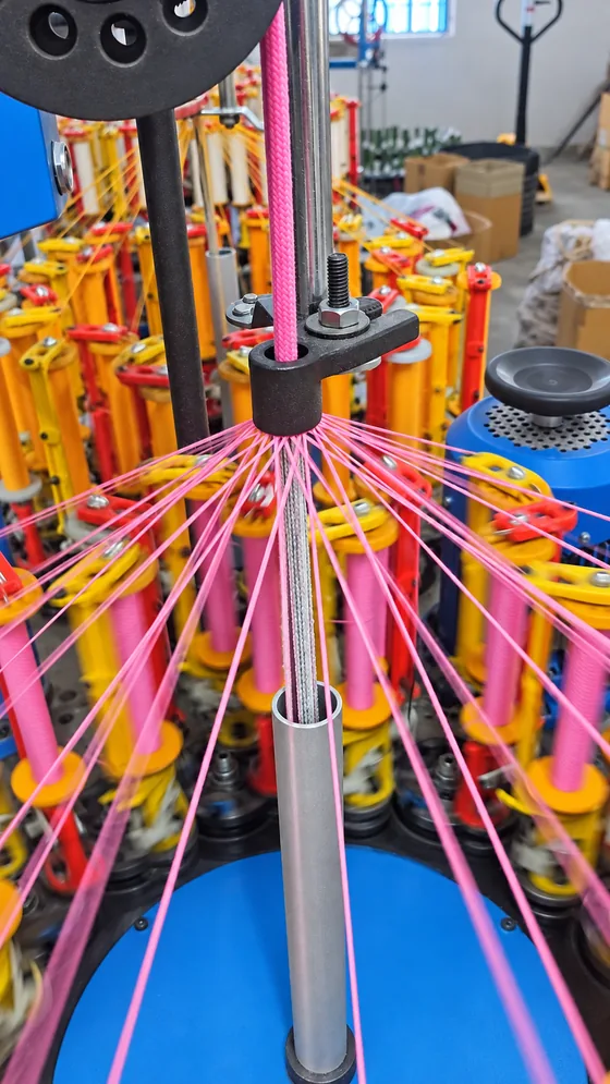 Pink threads forming a cord in our Jaipur factory