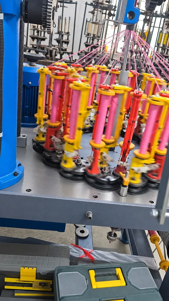 Pink cord braiding carriers in our Jaipur factory