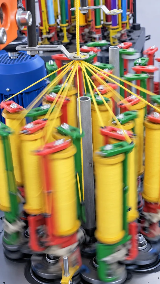 Yellow cord braiding carriers in our Jaipur factory