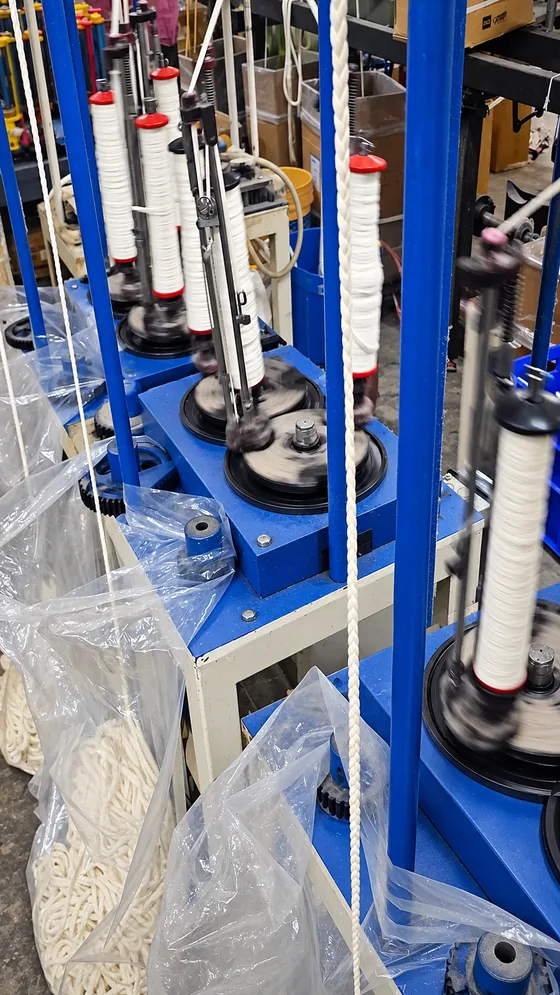 White yarn carriers along the line in our Jaipur factory