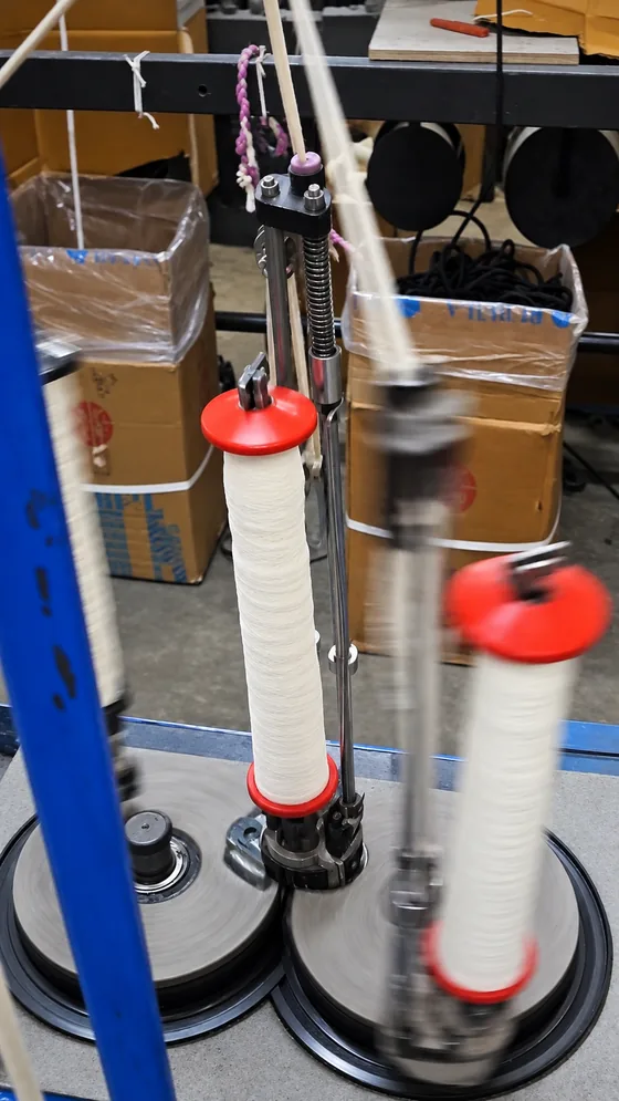 White yarn carrier in motion in our Jaipur factory