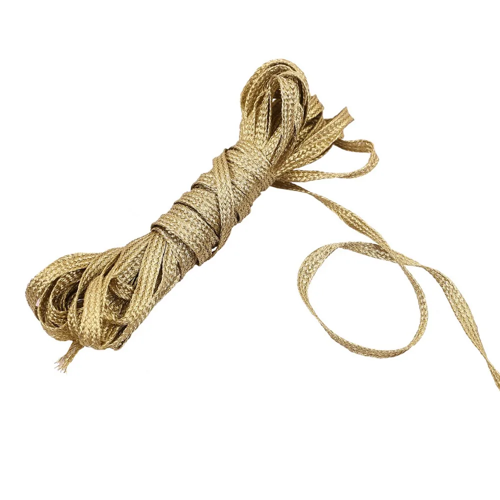 Gold zari braided ribbon in a hank with a loose length showing its flat profile